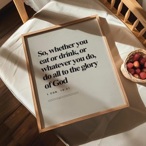 May include: A framed print with a white background and black text. The text reads "So, whether you eat or drink, or whatever you do, do all to the glory of God 1 COR. 10:31".