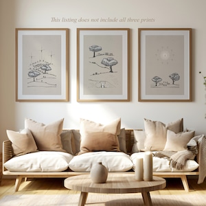 May include: Three framed black and white illustrations of trees, people, and a cross. The illustrations are on a beige background and are hung on a white wall above a light brown couch with beige pillows.