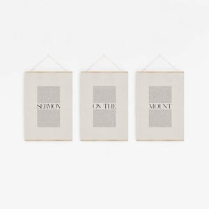 May include: Three framed prints with the text "SERMON ON THE MOUNT" printed in black on a beige background.