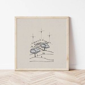 May include: A black and white line drawing of a crowd of people gathered on a hill with three crosses at the top. The drawing is framed in a light wood frame.
