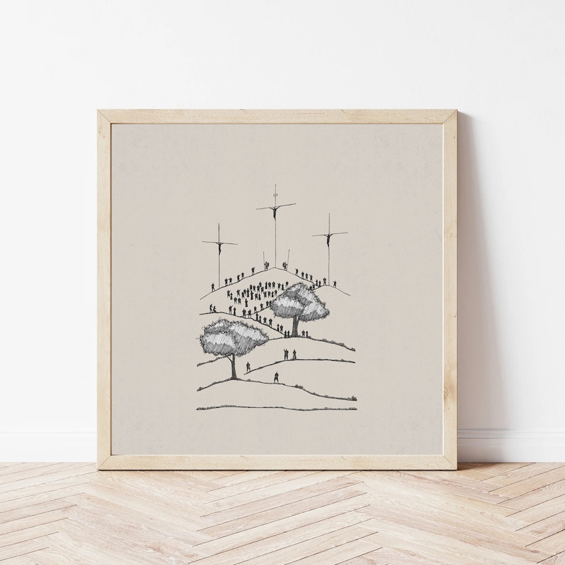 May include: A black and white line drawing of a crowd of people gathered on a hill with three crosses at the top. The drawing is framed in a light wood frame.