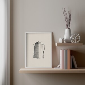 May include: A black and white line drawing of a coffee pot in a white frame on a wooden shelf with a vase of dried branches and a geometric metal sculpture.