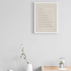 May include: A framed print with a beige background and black text. The text reads "Love, Joy, Peace, Patience, Kindness, Goodness, Faithfulness, Gentleness, Self Control".