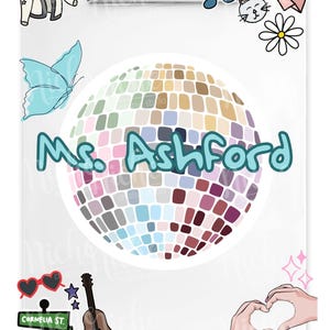 May include: A white clipboard with a disco ball design and the name "Ms. Ashford" in teal. The clipboard is decorated with various illustrations, including a butterfly, musical notes, and a guitar. Additional elements include a heart-shaped hand gesture and the number 13.