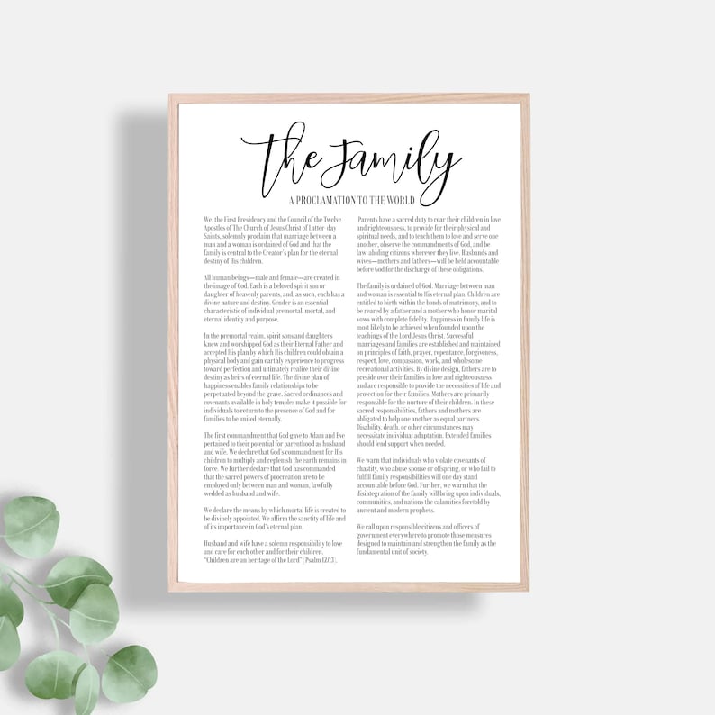 May include: A framed print with the text "The Family: A Proclamation to the World" in elegant script. The document outlines principles related to family, marriage, and parental responsibilities, with a light wood frame.