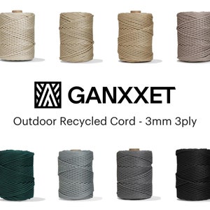 May include: Eight spools of 3mm 3-ply recycled cord in a variety of colours, including natural, beige, grey, black, and green. The spools are arranged in two rows of four. The text "GANXXET Outdoor Recycled Cord - 3mm 3ply" is displayed below the spools.