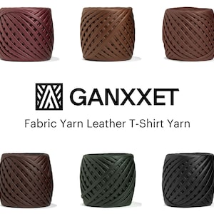 Puede incluir: Seis bobinas de hilo de tela en varios colores, incluyendo burdeos, marrón y negro. Las bobinas son de cuero y están etiquetadas como Hilo para camisetas. La marca GANXXET se muestra encima de la descripción del producto.