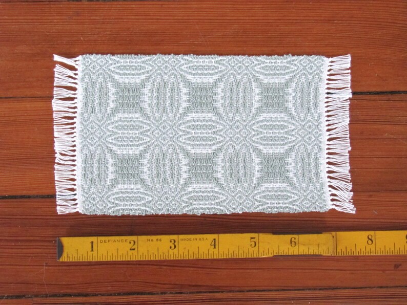 Handmade, Handcrafted 1:12 Scale Dollhouse Miniature Rug, Artisan Hand Woven Jade Green Carpet for Traditional Country Farmhouse or Modern Coastal Beach Cottage Decor is a perfect Doll House Furniture Accessory for your Miniature Bedroom or Living Room! Shown with ruler for scale.