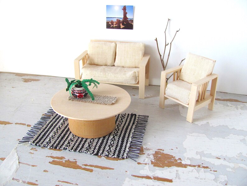 Handmade Inch to Foot Dollhouse Miniature Rug or Carpet,  1:12 Scale Artisan Hand Woven Black and Off-White Stripe and Diamond Pattern Scandinavian Modern, Rustic Farmhouse, Beach Cottage, or Southwest Desert Ranch Collector Dolls House Furniture Accessory Textile. Styled with a couch and chair, a floor vase with sticks, a potted cactus on a round coffee table, and a rock photo on the wall.