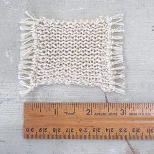 Little Handmade Half Inch to Foot Dollhouse Bed Throw Blanket, 1:24 Scale Miniature Artisan Hand Knit Ivory Cream White Bedspread, Doll House Furniture Bedroom Bedding, Collector Model Home Decor Accent Textile for Traditional Style or Modern Country Farmhouse, Cabin, or Cottage. Shown with ruler for scale.
