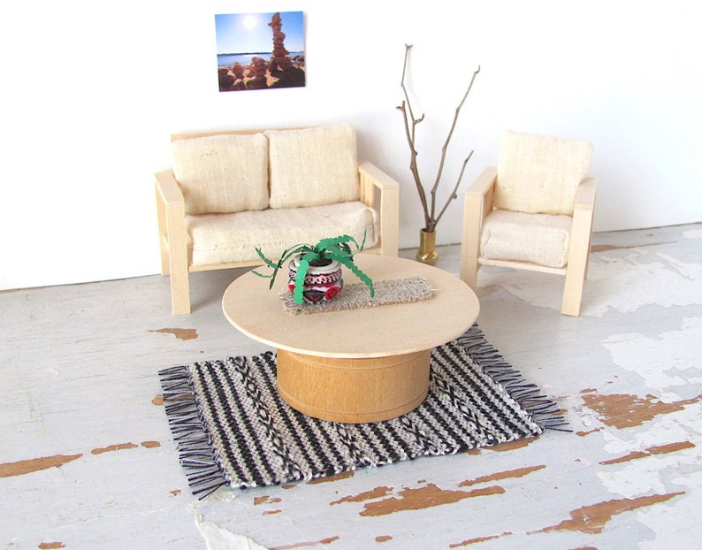 Handmade Inch to Foot Dollhouse Miniature Rug or Carpet,  1:12 Scale Artisan Hand Woven Black and Off-White Stripe and Diamond Pattern Scandinavian Modern, Rustic Farmhouse, Beach Cottage, or Southwest Desert Ranch Collector Dolls House Furniture Accessory Textile. Styled with a couch and chair, a floor vase with sticks, a potted cactus on a round coffee table, and a rock photo on the wall.