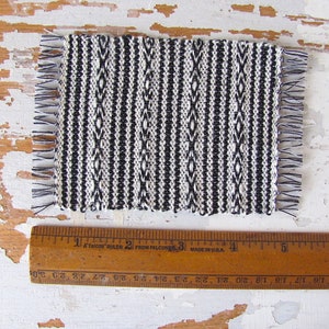 Handmade Inch to Foot Dollhouse Miniature Rug or Carpet,  1:12 Scale Artisan Hand Woven Black and Off-White Stripe and Diamond Pattern Scandinavian Modern, Rustic Farmhouse, Beach Cottage, or Southwest Desert Ranch Collector Dolls House Furniture Accessory Textile. Shown with ruler for scale.