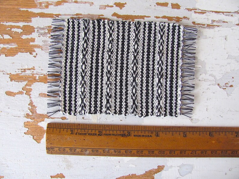 Handmade Inch to Foot Dollhouse Miniature Rug or Carpet,  1:12 Scale Artisan Hand Woven Black and Off-White Stripe and Diamond Pattern Scandinavian Modern, Rustic Farmhouse, Beach Cottage, or Southwest Desert Ranch Collector Dolls House Furniture Accessory Textile. Shown with ruler for scale.