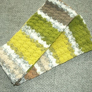 May include: A crocheted scarf with stripes of green, yellow, white and brown.