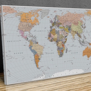 May include: A vintage-style world map with a light blue background and a grid pattern. The continents are outlined in brown and filled with various shades of beige, yellow, and green. The oceans are labelled with the words "Pacific Ocean", "Atlantic Ocean", and "Indian Ocean".