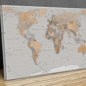 May include: A world map printed on a canvas with a light grey background and brown and grey continents. The map includes country borders and names, as well as ocean names.