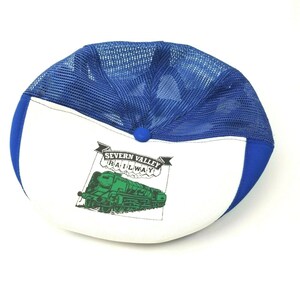 May include: A white and blue baseball cap with a green and black train logo that says "Severn Valley Railway".
