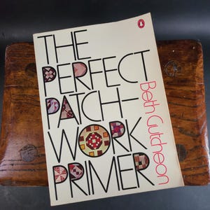 May include: A book titled "The Perfect Patchwork Primer" by Beth Gutcheon. The cover features a colorful patchwork design and the title is in bold, black font.