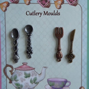 May include: A decorative card with the text "Cutlery Moulds" features miniature spoons, a fork, and a knife. A teapot and teacup are also illustrated. The card has a light blue background with decorative elements.