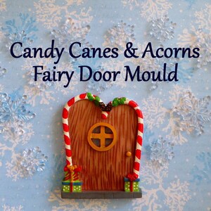 May include: A whimsical fairy door mold with a candy cane frame and a wooden door. The door features a round window with a cross design and is flanked by two gift boxes. The background is a light blue with snowflake accents. Text on the image reads "Candy Canes & Acorns Fairy Door Mould."