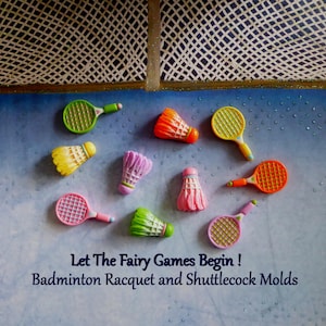 May include: Colorful badminton racket and shuttlecock molds in various colors, including green, orange, pink, and yellow. The text "Let The Fairy Games Begin! Badminton Racquet and Shuttlecock Molds" is displayed below the molds.