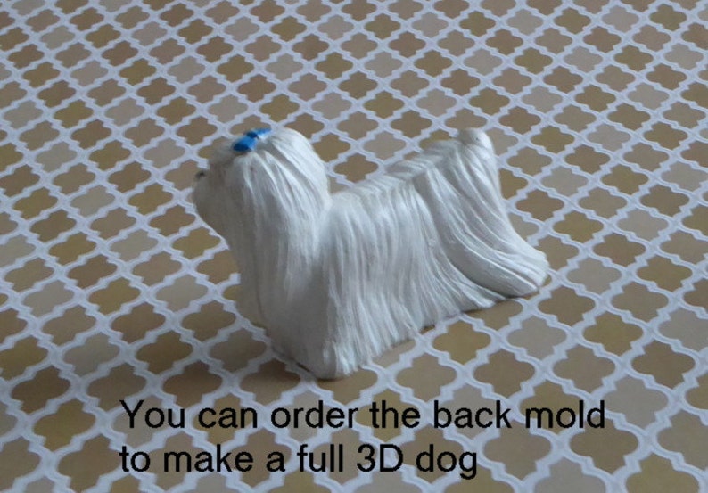 May include: A white dog figurine with long, flowing fur and a small blue bow. The figurine is on a patterned surface. Text on the image reads: "You can order the back mold to make a full 3D dog."