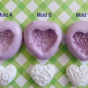 May include: Three heart-shaped silicone molds in lavender, each with a different embossed design: flowers, small blossoms, and a swirling pattern. Below, three white heart-shaped castings showcase the mold designs. The text "Mold A", "Mold B", and "Mold C" are visible.