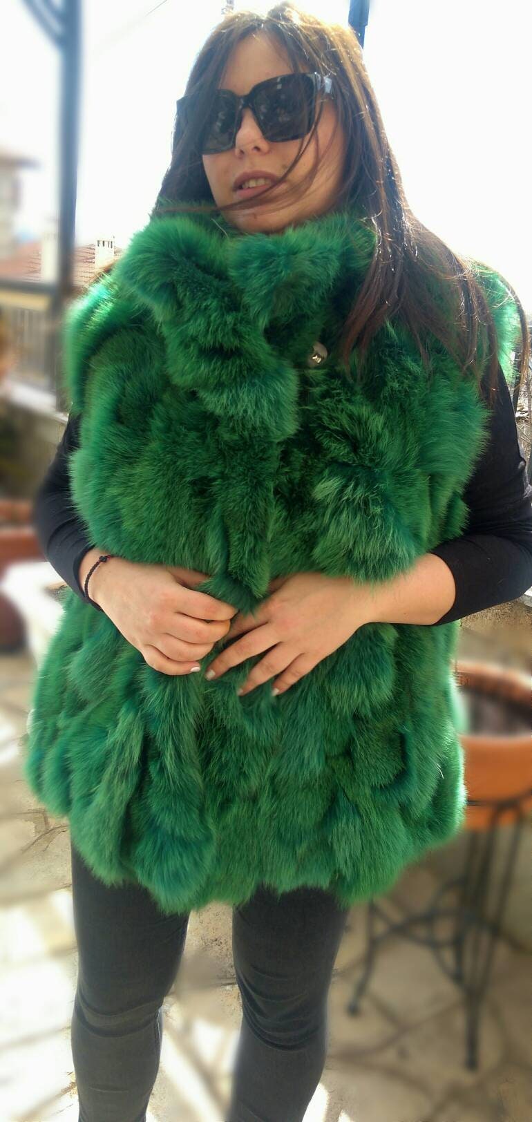 Green vest shop with fur hood
