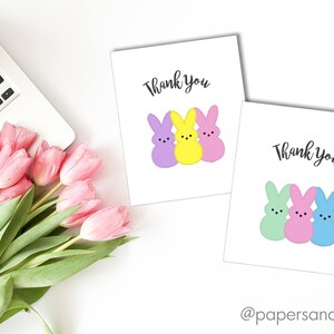 May include: Two printable thank you cards featuring pastel colored bunny illustrations. The first card has a purple, yellow, and pink bunny. The second card has a green, pink, and blue bunny. Both cards say "Thank You" in black text.