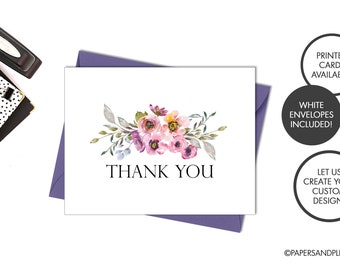 May include: A white thank you card with a watercolor floral design in shades of pink, purple, and green. The text "THANK YOU" is printed in black below the floral design.