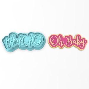 May include: Two cookie cutters, one blue and one pink, with the text "Oh Baby" in a cursive font.
