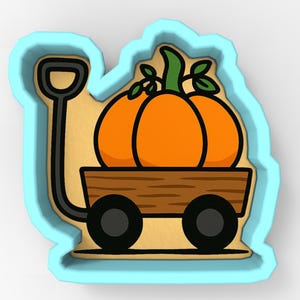 May include: A pumpkin-themed cookie cutter in the shape of a wagon carrying a large orange pumpkin with green leaves. The wagon has black wheels and a brown bed. The cutter has a light blue outline.