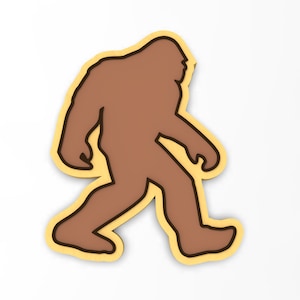 May include: A brown silhouette of Bigfoot walking, outlined in black and set against a yellow background.