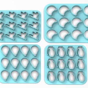 K&ouml;nnte beinhalten: Vier S&auml;tze blauer Plastik-Ausstecher. Der erste Satz hat 12 Entenformen. Der zweite Satz hat 12 Halbmondformen. Der dritte Satz hat 12 Hei&szlig;luftballonformen. Der vierte Satz hat 12 Granatenformen.