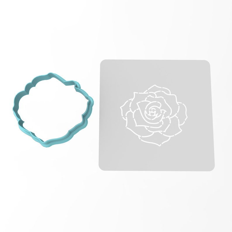 May include: A light blue plastic cookie cutter shaped like a rose, next to a white stencil of a rose on a gray background.