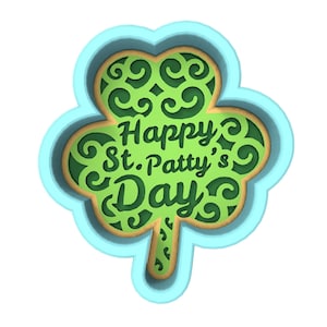 May include: A blue and green shamrock cookie cutter with the text "Happy St. Patty's Day" inside.
