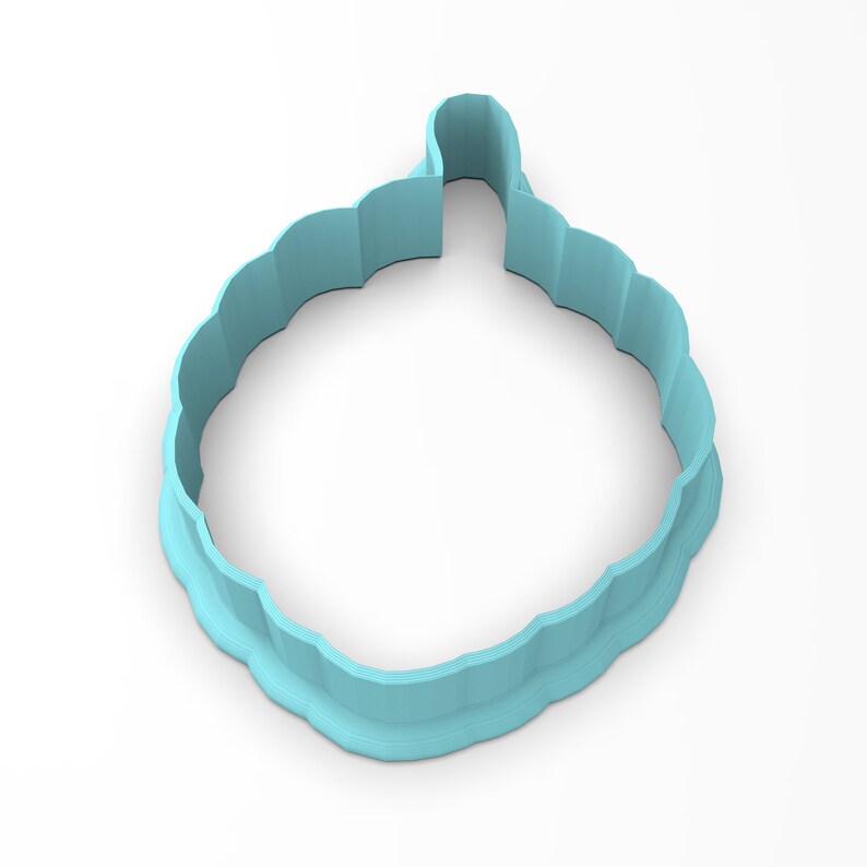 May include: A light blue plastic cookie cutter shaped like a cloud with a scalloped edge.