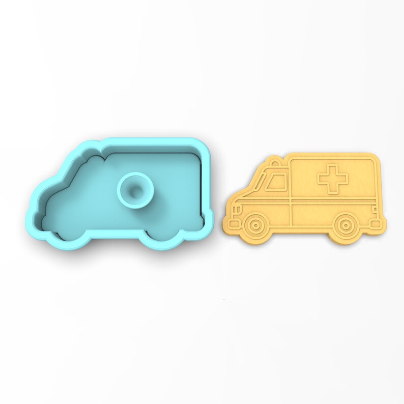 May include: A light blue plastic cookie cutter shaped like an ambulance, next to a yellow cookie cut out in the shape of an ambulance.