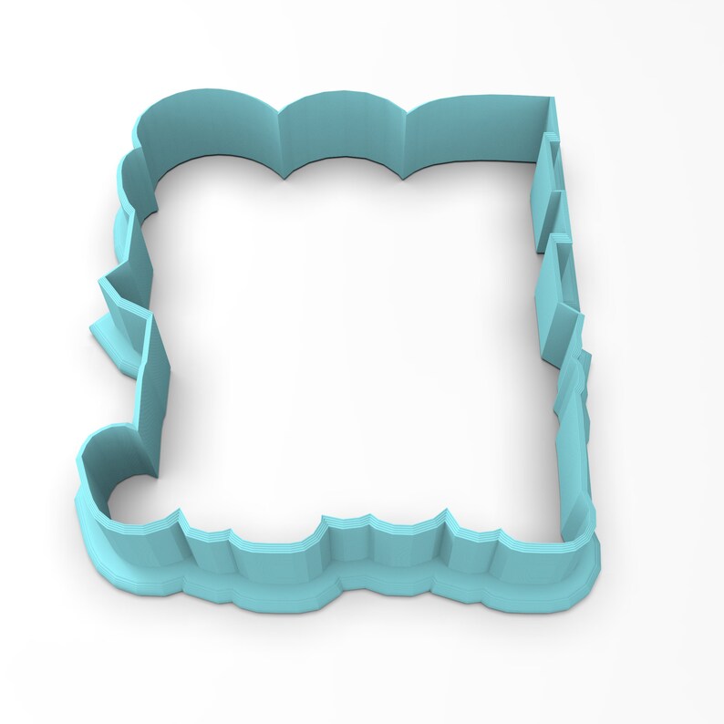 May include: A light blue plastic cookie cutter shaped like a rectangle with a decorative, scalloped edge.