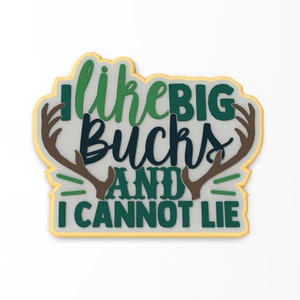 May include: A green and brown cookie with the text "I like big bucks and I cannot lie" and a pair of antlers.