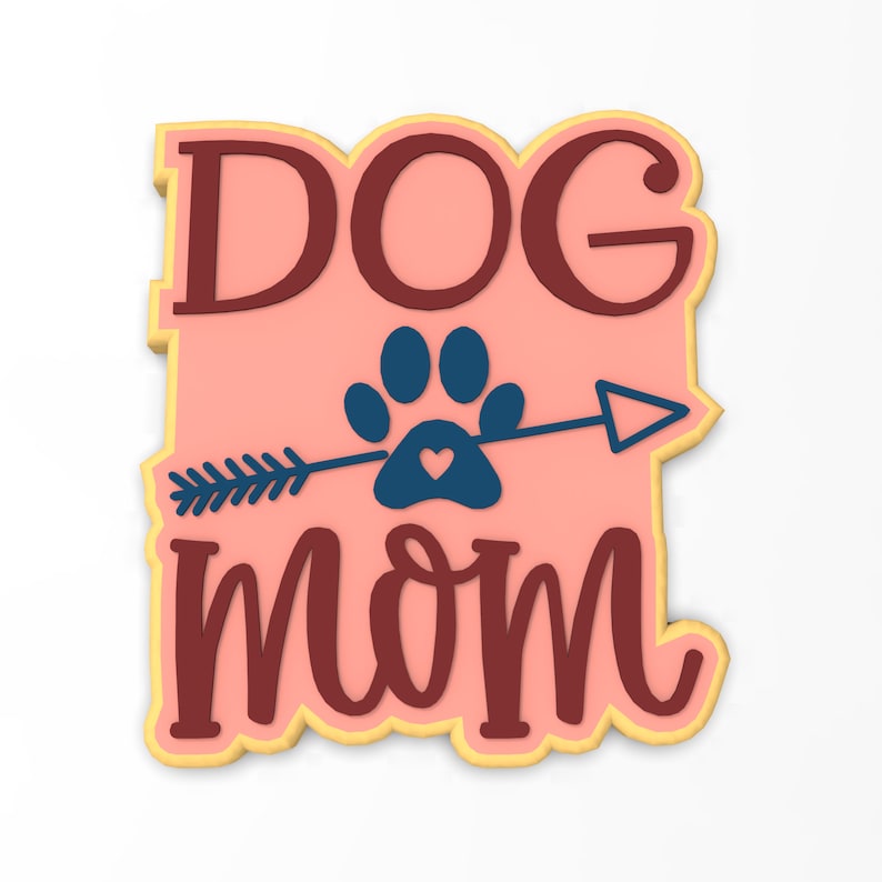 May include: A pink and brown cookie with the text "DOG MOM" and a paw print with an arrow through it. The paw print has a small heart in the center.