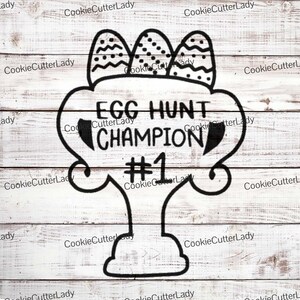 May include: Black and white graphic design of an egg hunt trophy with three eggs on top and the text "EGG HUNT CHAMPION #1".