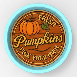 May include: A round sign with a light blue border and a wooden center. The center features an orange pumpkin illustration and the words "FRESH PUMPKINS PICK YOUR OWN" in a decorative font.