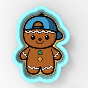 May include: A cartoon gingerbread man wearing a blue baseball cap, with a light blue outline. The gingerbread man has a brown body, white icing details, and two colored buttons. The design is a cookie cutter.