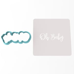 May include: A light blue plastic cookie cutter in the shape of the words "Oh Baby" with a white background behind it. The words "Oh Baby" are written in a cursive font.