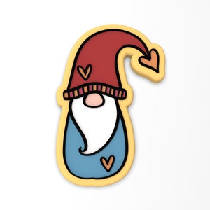 May include: A yellow outlined cookie cutter shaped like a gnome with a red hat, a blue beard, and three orange hearts.