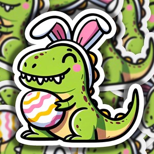 May include: A green dinosaur wearing bunny ears holds a pink, yellow, and white striped Easter egg. The dinosaur is smiling and has a pink blush on its cheek.