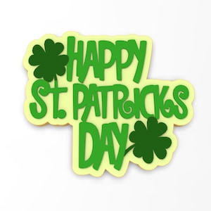 Może przedstawiać: Zielono-żółta dekoracja na Dzień Świętego Patryka. Napis "HAPPY ST. PATRICK'S DAY" jest w kolorze zielonym, z dwoma zielonymi koniczynami. Tło jest jasnożółte, a krawędzie ciemniejsze.