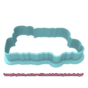 May include: A light blue plastic cookie cutter shaped like a cloud with a scalloped edge.