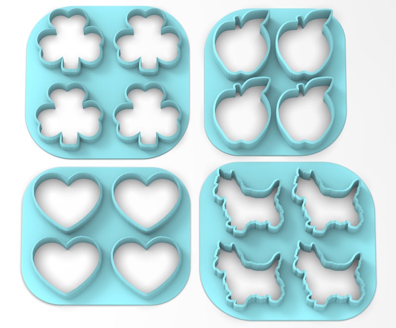 May include: Set of four blue plastic cookie cutters, each with a different design: a four-leaf clover, an apple, a heart, and a terrier dog.